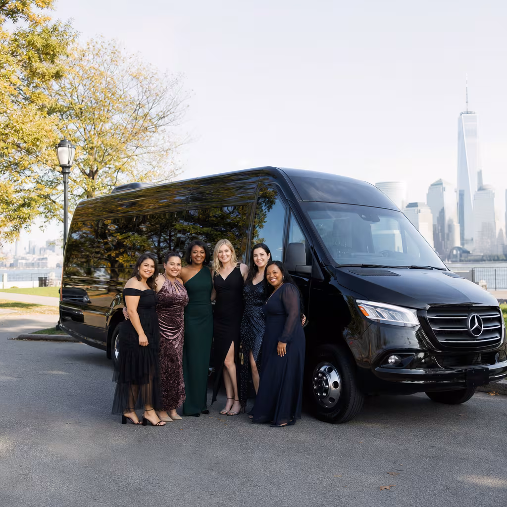 Group beside a Mercedes Sprinter limo from the Jersey City fleet at the beach