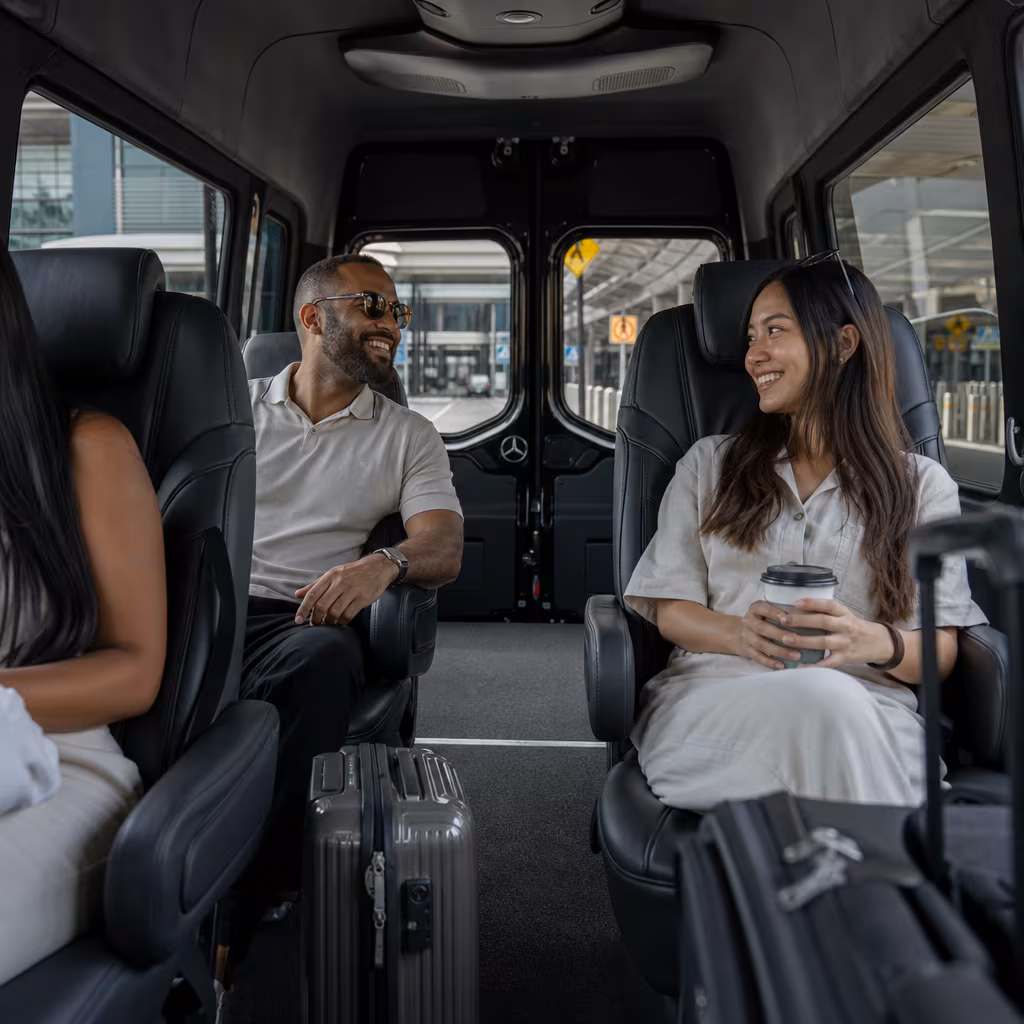 Passengers loading luggage while boarding an Jersey City group shuttle