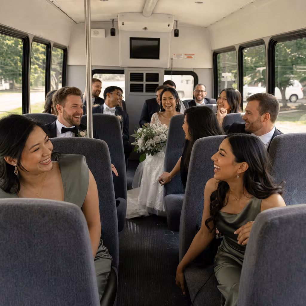 Group boarding a white charter bus for Wedding Transportation transportation in Jersey City